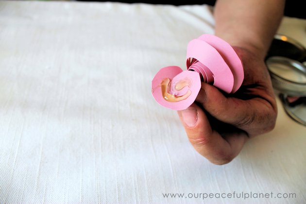 Make these beautiful DIY paper flowers in 5 minutes or less! Use them in your crafts or decorating. Attach them to a lamp shade. Even use them in your hair!