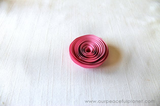 Make these beautiful DIY paper flowers in 5 minutes or less! Use them in your crafts or decorating. Attach them to a lamp shade. Even use them in your hair!