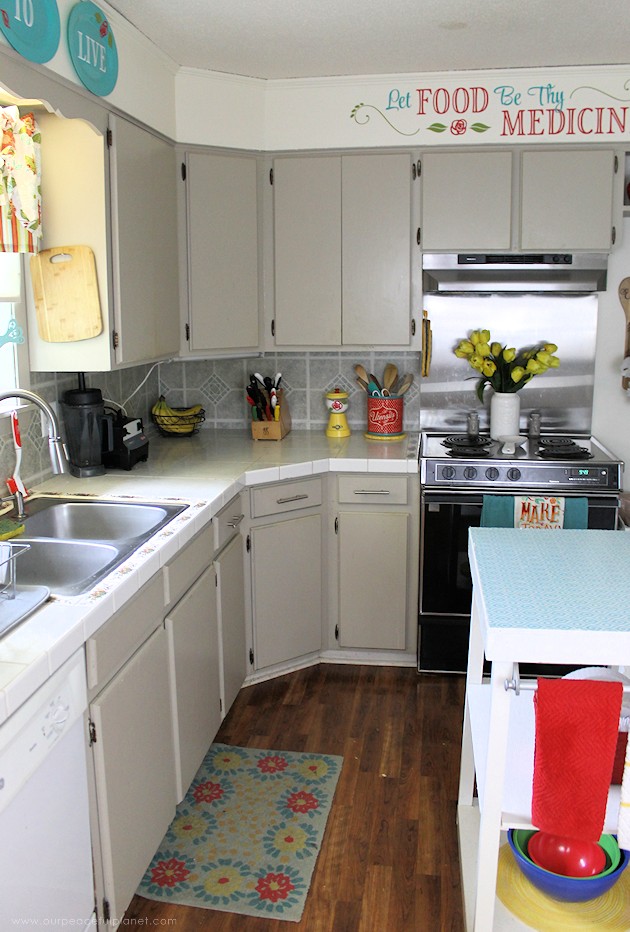 See the final reveal of our outdated kitchen transformation, completed with a minimum of cash. It's now a fun, inspiring place to be. Before & after photos!