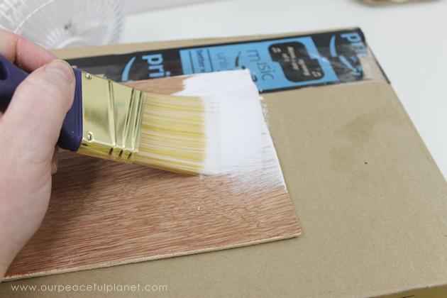 Learn how to make an inexpensive pull out cabinet organizer using a cardboard box so you can easily access things in the far reaches of your lower cabinets.