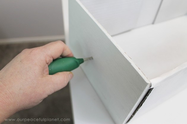 Learn how to make an inexpensive pull out cabinet organizer using a cardboard box so you can easily access things in the far reaches of your lower cabinets.