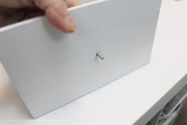 Learn how to make an inexpensive pull out cabinet organizer using a cardboard box so you can easily access things in the far reaches of your lower cabinets.
