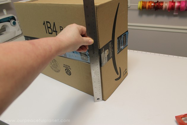 Learn how to make an inexpensive pull out cabinet organizer using a cardboard box so you can easily access things in the far reaches of your lower cabinets.