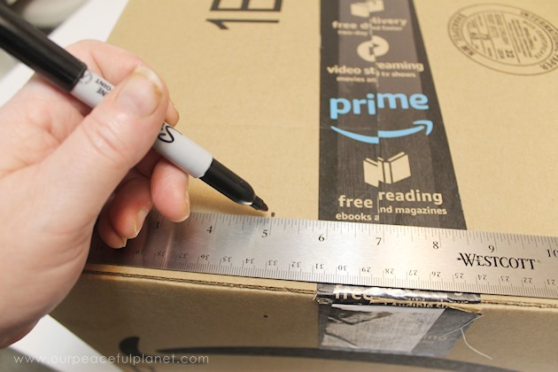 Learn how to make an inexpensive pull out cabinet organizer using a cardboard box so you can easily access things in the far reaches of your lower cabinets.