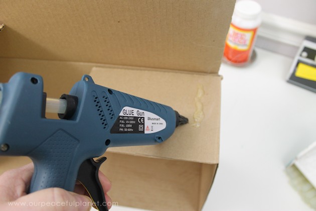 Learn how to make an inexpensive pull out cabinet organizer using a cardboard box so you can easily access things in the far reaches of your lower cabinets.