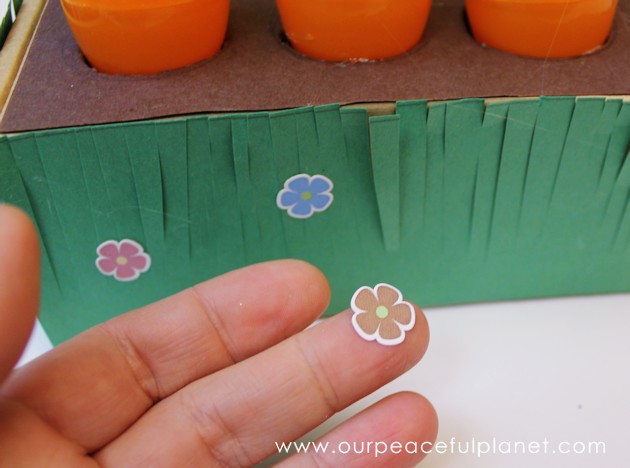 Make this cute carrot garden diy Easter basket using plastic eggs, a box and some construction paper! You can fill the box and the carrot eggs with goodies.