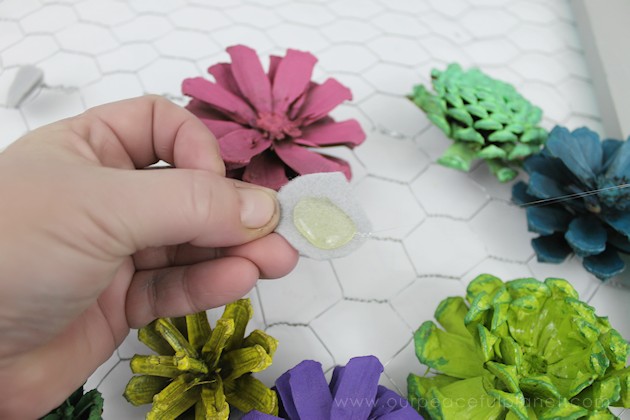 A country chicken wire frame memo board that will brighten up your kitchen with its pretty pinecone succulents. It holds useful items plus photos & quotes!