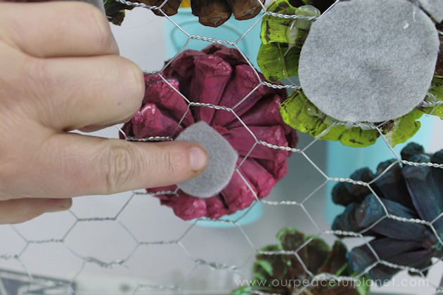 A country chicken wire frame memo board that will brighten up your kitchen with its pretty pinecone succulents. It holds useful items plus photos & quotes!