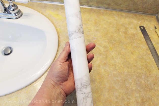 Transform your bathroom for only a few dollars with a contact paper countertop. You'll be amazed at how beautiful it looks & so will your family & guests!