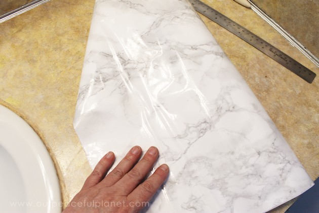 Transform your bathroom for only a few dollars with a contact paper countertop. You'll be amazed at how beautiful it looks & so will your family & guests!