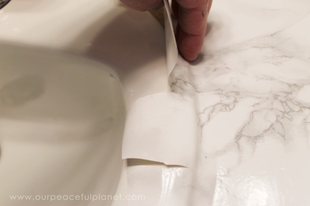 Transform your bathroom for only a few dollars with a contact paper countertop. You'll be amazed at how beautiful it looks & so will your family & guests!