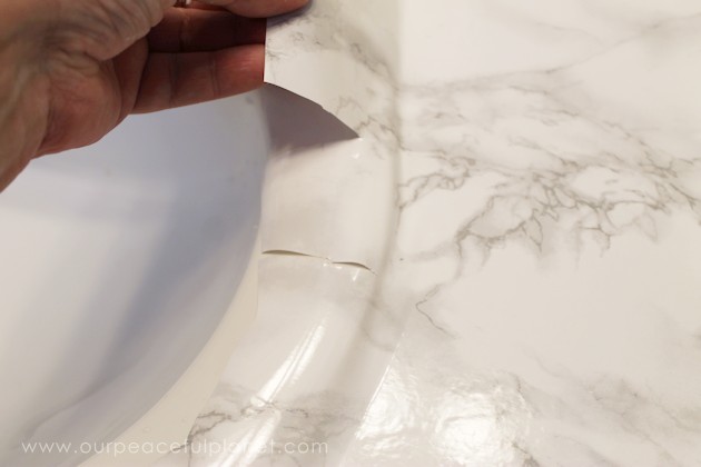Transform your bathroom for only a few dollars with a contact paper countertop. You'll be amazed at how beautiful it looks & so will your family & guests!