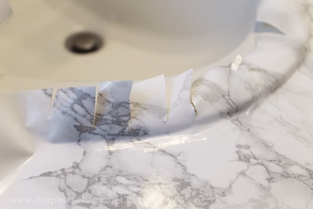 Transform your bathroom for only a few dollars with a contact paper countertop. You'll be amazed at how beautiful it looks & so will your family & guests!