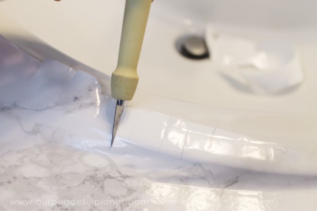 Transform your bathroom for only a few dollars with a contact paper countertop. You'll be amazed at how beautiful it looks & so will your family & guests!