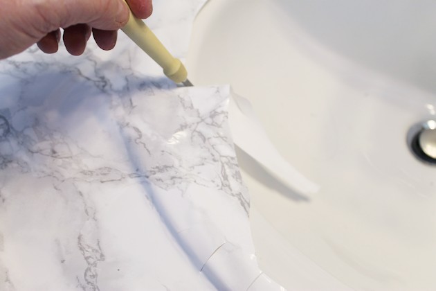 Transform your bathroom for only a few dollars with a contact paper countertop. You'll be amazed at how beautiful it looks & so will your family & guests!