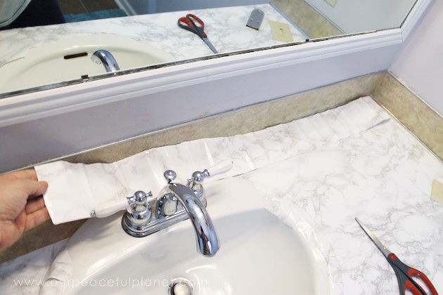 Transform your bathroom for only a few dollars with a contact paper countertop. You'll be amazed at how beautiful it looks & so will your family & guests!