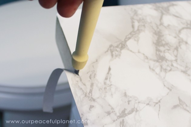 Transform your bathroom for only a few dollars with a contact paper countertop. You'll be amazed at how beautiful it looks & so will your family & guests!