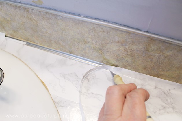 Transform your bathroom for only a few dollars with a contact paper countertop. You'll be amazed at how beautiful it looks & so will your family & guests!