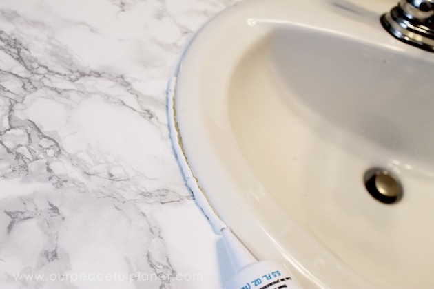 Transform your bathroom for only a few dollars with a contact paper countertop. You'll be amazed at how beautiful it looks & so will your family & guests!