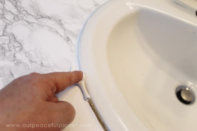 Transform your bathroom for only a few dollars with a contact paper countertop. You'll be amazed at how beautiful it looks & so will your family & guests!