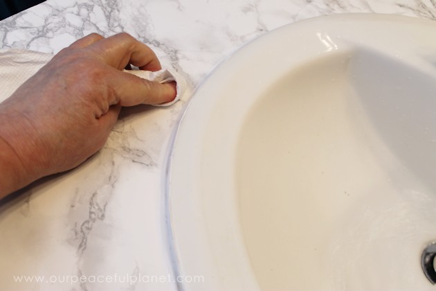 Transform your bathroom for only a few dollars with a contact paper countertop. You'll be amazed at how beautiful it looks & so will your family & guests!