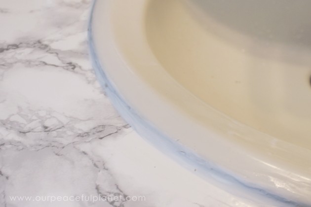 Transform your bathroom for only a few dollars with a contact paper countertop. You'll be amazed at how beautiful it looks & so will your family & guests!
