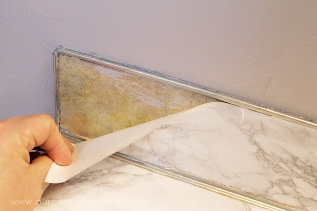 Transform your bathroom for only a few dollars with a contact paper countertop. You'll be amazed at how beautiful it looks & so will your family & guests!