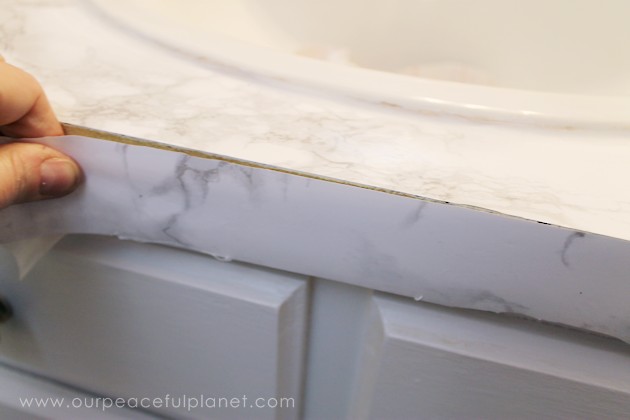 Transform your bathroom for only a few dollars with a contact paper countertop. You'll be amazed at how beautiful it looks & so will your family & guests!