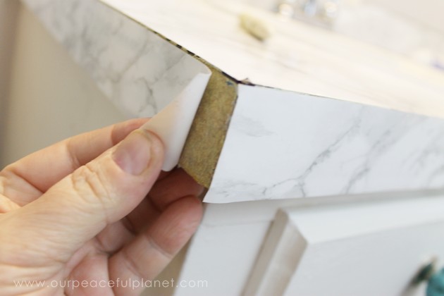 Transform your bathroom for only a few dollars with a contact paper countertop. You'll be amazed at how beautiful it looks & so will your family & guests!