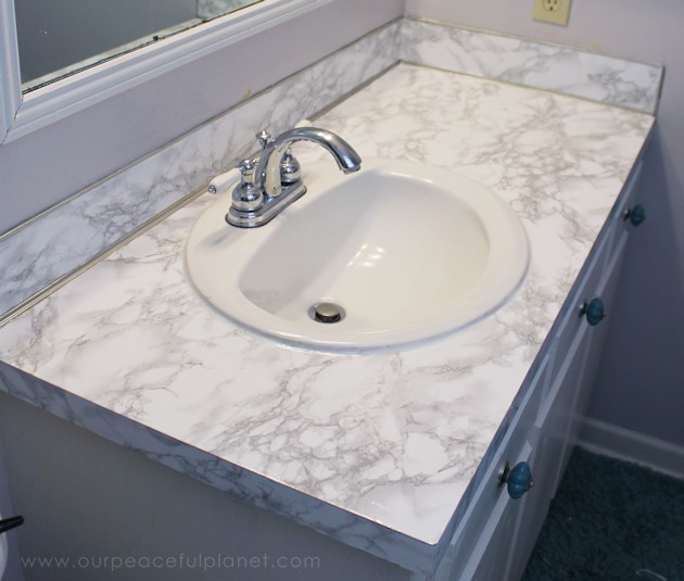 Transform your bathroom for only a few dollars with a contact paper countertop. You'll be amazed at how beautiful it looks & so will your family & guests!