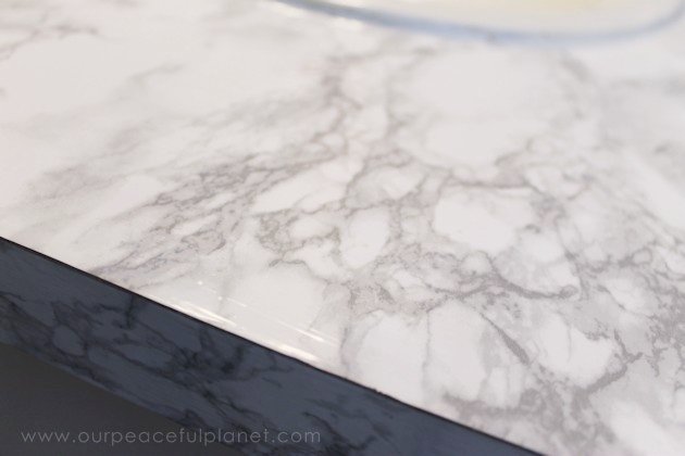 Transform your bathroom for only a few dollars with a contact paper countertop. You'll be amazed at how beautiful it looks & so will your family & guests!
