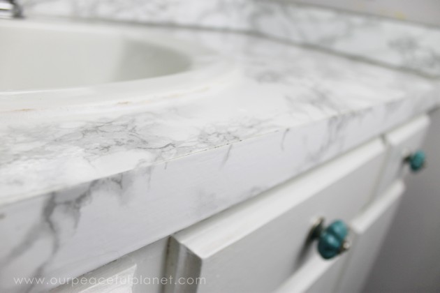 Transform your bathroom for only a few dollars with a contact paper countertop. You'll be amazed at how beautiful it looks & so will your family & guests!