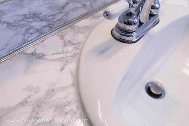Transform your bathroom for only a few dollars with a contact paper countertop. You'll be amazed at how beautiful it looks & so will your family & guests!