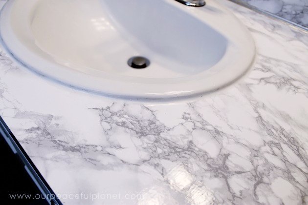 Transform your bathroom for only a few dollars with a contact paper countertop. You'll be amazed at how beautiful it looks & so will your family & guests!