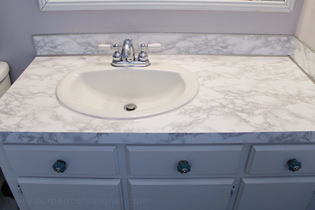 Transform your bathroom for only a few dollars with a contact paper countertop. You'll be amazed at how beautiful it looks & so will your family & guests!