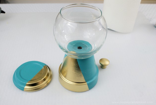 A beautiful gold & teal version of the classic DIY gumball machine, made from a clay pot & a glass bowl. Use it for gum, candy or a variety of other things!