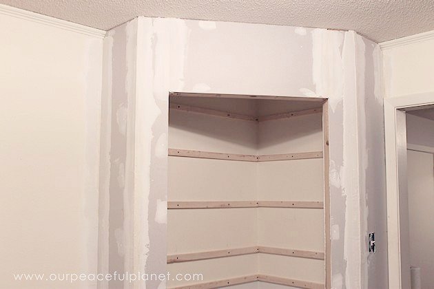 Add space and convenience to your small kitchen with this simple DIY pantry! It has floor to ceiling shelves, a door and it fits perfectly into a corner.