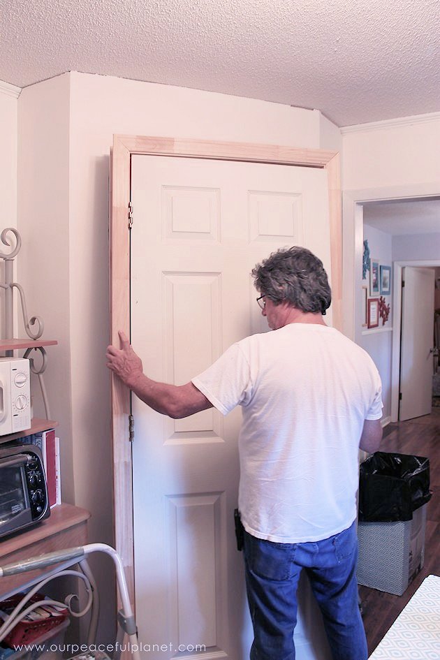Add space and convenience to your small kitchen with this simple DIY pantry! It has floor to ceiling shelves, a door and it fits perfectly into a corner.