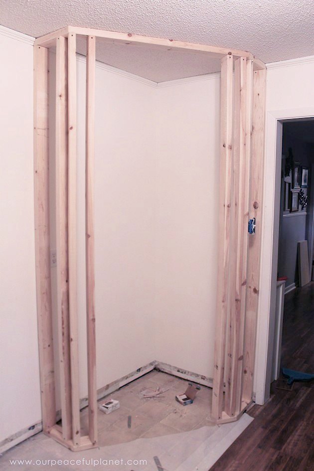 Add space and convenience to your small kitchen with this simple DIY pantry! It has floor to ceiling shelves, a door and it fits perfectly into a corner.