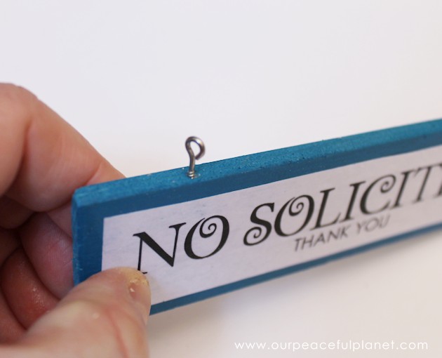 Make these small eye catching wood no soliciting signs that easily hang on windows or doors. A 1.5" wood slat and our free printables will get you started!