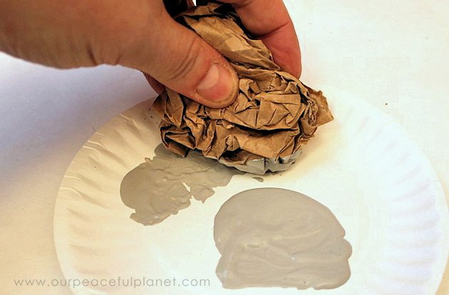 You won't believe how easy & inexpensive it is to do a dramatic fireplace makeover! All you need is some normal paint and a wadded up paper bag. No kidding!