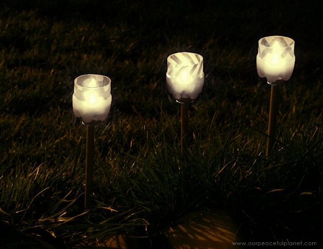 Make your outdoor pathways shine and glimmer with these elegant gold and silver path lights made from soda bottles, dowels and battery operated tea lights.