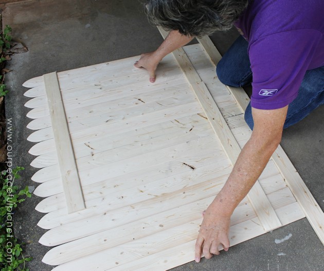 Add some whimsy to your home with this easy DIY picket fence fireplace cover. Made with wood slats and some hinges you can decorate it for any season. 