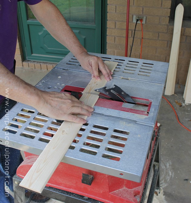 Add some whimsy to your home with this easy DIY picket fence fireplace cover. Made with wood slats and some hinges you can decorate it for any season. 