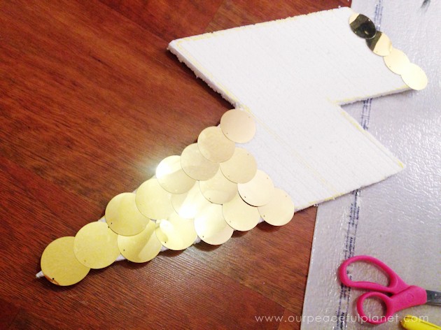 With a foam sheet, 40mm round gold sequins and hot glue you can make this awesome huge lightning bolt cheap wall decor statement piece. Shockingly gorgeous!