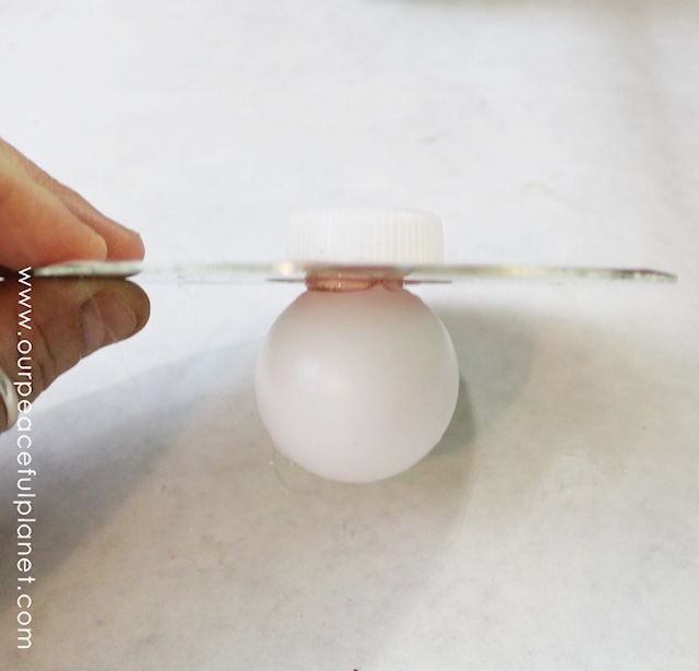 Spin tops might be old fashioned but these custom tops made from a CD a ping pong ball and a soda lid are a blast played in a group, and they spin forever!