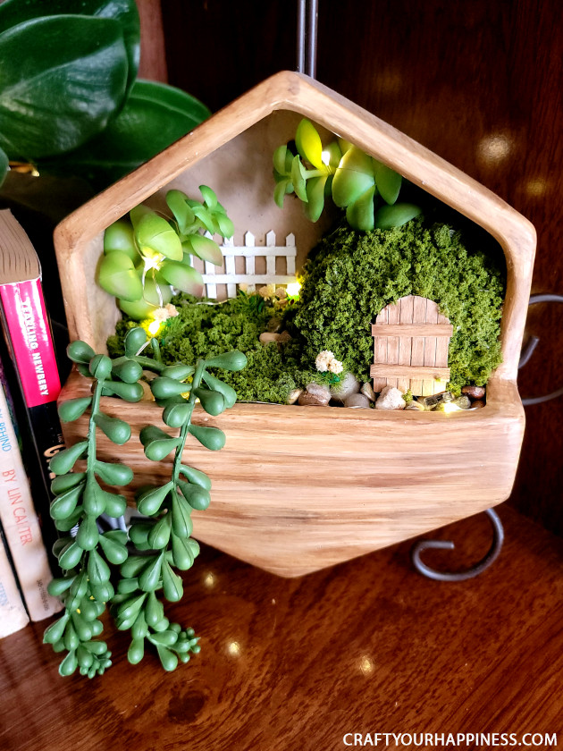 Get Inspired and check out this small hanging planter we turned into a whimsical fairy garden!