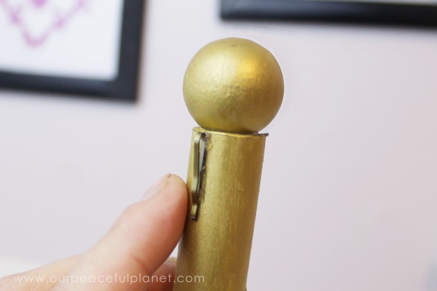 This classy display clip stand is made from a candle holder, dowel and bobby pin and it can not only display he free printable motivational quotes below but photos and more!