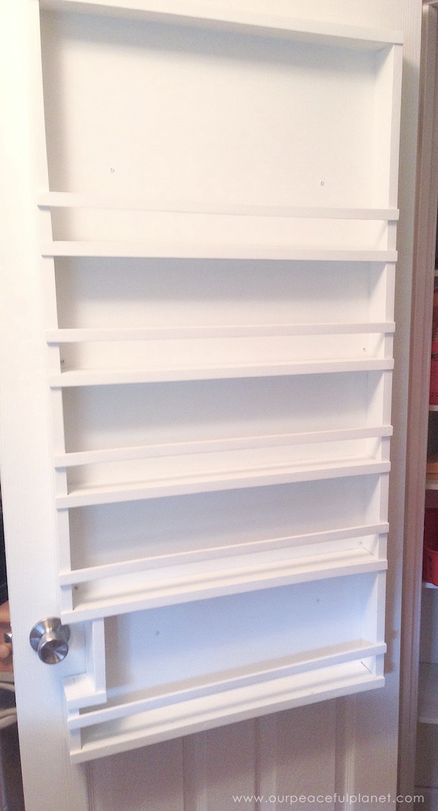Build your own affordable pantry door organizer with some wood and a few basic tools. It's easier than you think and you'll love the extra storage!