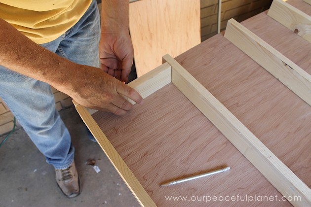 Build your own affordable pantry door organizer with some wood and a few basic tools. It's easier than you think and you'll love the extra storage!